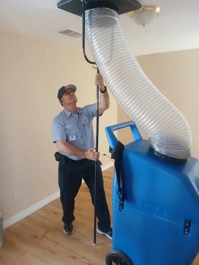 Furnace Tune-Up technician using HEPA equipment in Yorba Linda